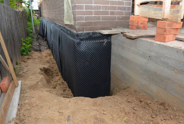 SJ Waterproofing Pros technician performing targeted Wet Basement Repair assessment in Aurora, IN